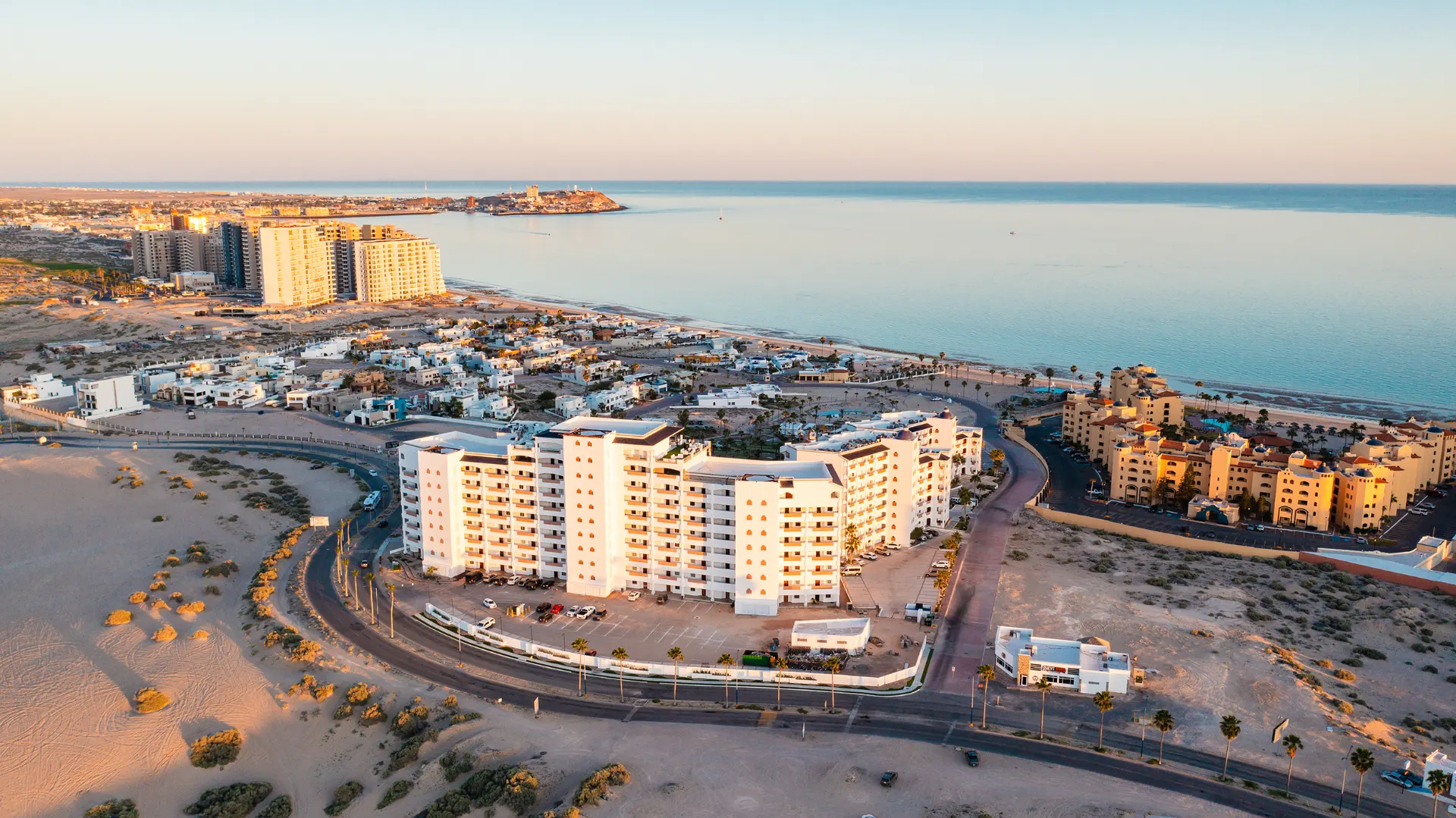 Aerial sunset view of Casa Blanca Golf Villas in Sandy Beach, Rocky Point, with the Sea of Cortez